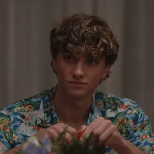 Curly Haired Manin Floral Shirt Wallpaper