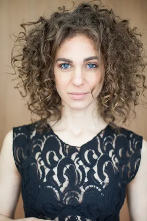 Curly Haired Woman With Blue Eyes Wallpaper