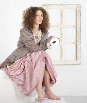 Curly Haired Woman With Mask And Vintage Outfit Wallpaper