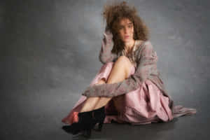 Curly Haired Womanin Pink Dressand Black Heels Wallpaper