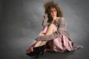 Curly Haired Womanin Pink Dressand Black Heels Wallpaper