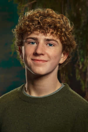 Curly Haired Youth Smiling Portrait Wallpaper