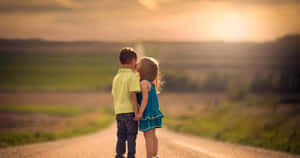 Cute Baby Couple Kiss In Sunset Wallpaper