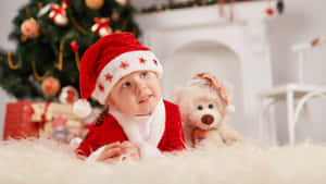 Cute Baby In Christmas Hat Wallpaper