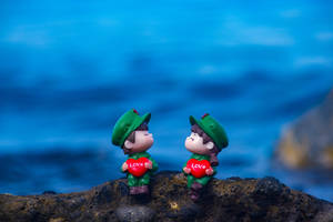 Cute Blue Couple Toy Figures Wallpaper