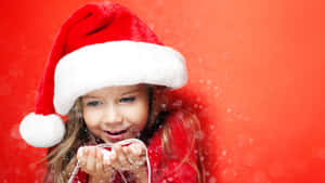Cute Girl Wearing Christmas Hat Wallpaper