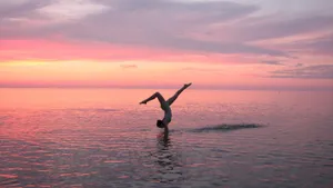 Cute Gymnastics Handstand On Beach Wallpaper