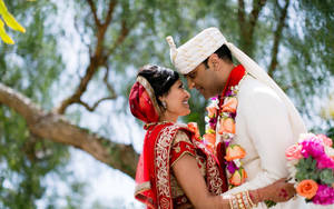 Cute Indian Couple In Wedding Attire Wallpaper