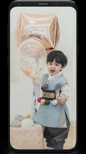Cute Korean Toddler Wearing Traditional Korean Attire Wallpaper