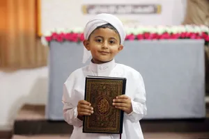 Cute Muslim Boy Holding Quran Wallpaper