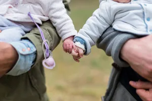 Cute Photo Of Two Babies Holding Each Other's Tangible Hand Wallpaper