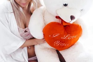 Cute Teddy Bear On Her Lap Wallpaper