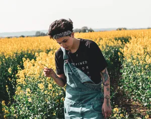 Cute Tomboy In Flower Field Wallpaper