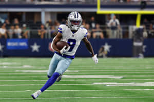 Dallas Cowboys Player Runningon Field Wallpaper