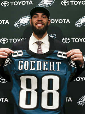 Dallas Goedert Holding Eagles Jersey Wallpaper