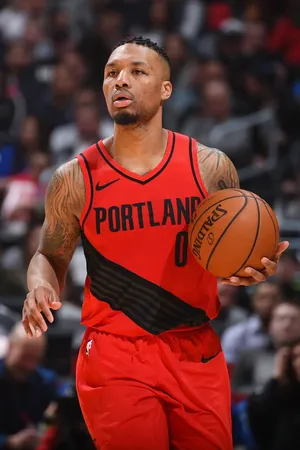 Damian Lillard In Red Uniform Portrait Wallpaper