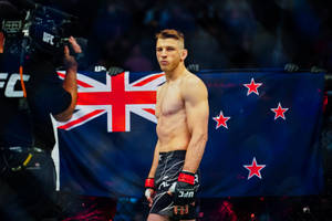 Dan Hooker Standing With Flag Wallpaper