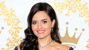 Danica Mckellar Smiling Elegantly In A Formal Dress Wallpaper