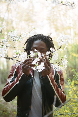 Daniel Caesar Smelling Flowers Wallpaper