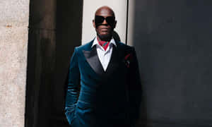 Dapper Dan Leaning Against A Wall Wallpaper