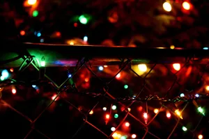 Dark Christmas Lights Fence Glow Wallpaper
