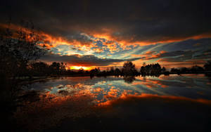 Dark Clouds Breaking Over Sunset Wallpaper