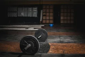 Dark Gymwith Barbellon Floor Wallpaper