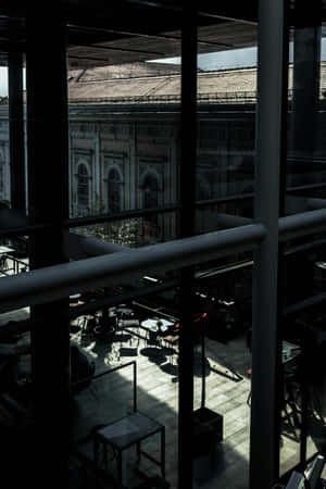 Dark Moody Cafe Interior With Natural Lighting Wallpaper