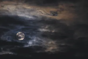Dark Moon Illuminating The Night Sky Wallpaper