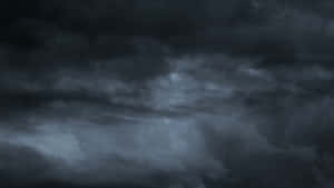 Dark Storm Approaching Over A Barren Landscape Wallpaper