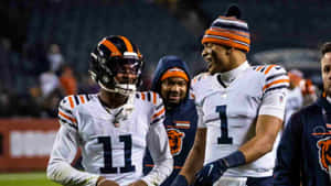 Darnell Mooneyand Teammate Walking Off Field Wallpaper