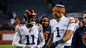 Darnell Mooneyand Teammate Walking Off Field Wallpaper