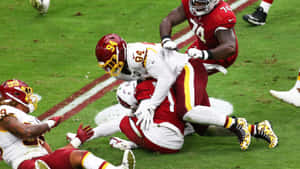 Daron Payne Tackling Opponent During Game Wallpaper