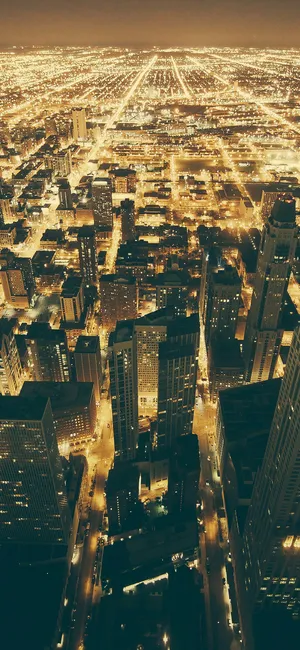 Dazzling Lights Illuminate The City Of Chicago At Night Wallpaper