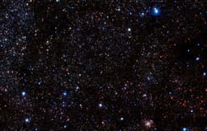 Dazzling Star Cluster Shining Brightly In The Night Sky Wallpaper