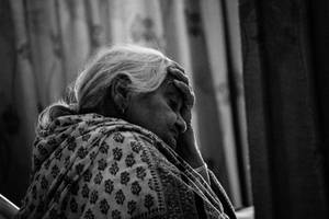 Deep In Thought - A Pensive Old Woman Wallpaper