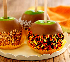 Delectable Caramel Apples With Chopped Nuts Wallpaper