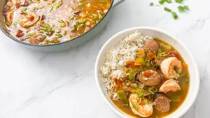 Delectable Gumbo In Pan And Plate With Rice On Marble Surface Wallpaper