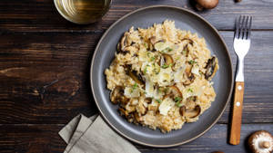 Delectable Mushroom Risotto Garnished To Perfection Wallpaper