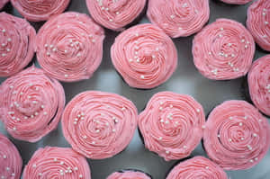 Delectable Pink Cupcakes With Colorful Sprinkles Wallpaper