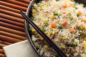 Delicious Fried Rice Served With Chopsticks Wallpaper