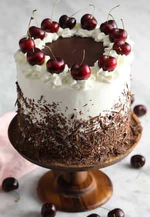 Delicious Layers Of Black Forest Cake With Fresh Cherries And Rich Chocolate Shavings. Wallpaper