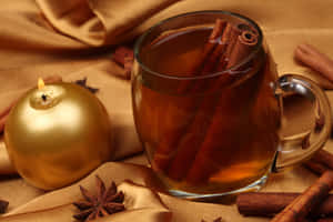 Delicious Mulled Wine In A Glass With Festive Decorations Wallpaper