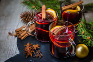 Delicious Mulled Wine With Winter Spices And Citrus Fruits In A Cozy Atmosphere Wallpaper