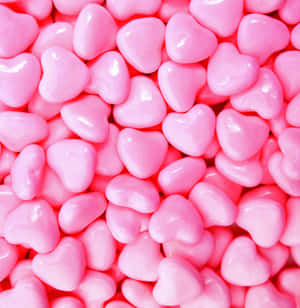 Delicious Pink Candies Scattered On A Surface Wallpaper