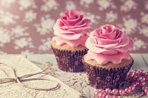 Delicious Pink Cupcakes On Display Wallpaper