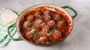 Delicious Red Sauce In A White Ceramic Bowl Wallpaper