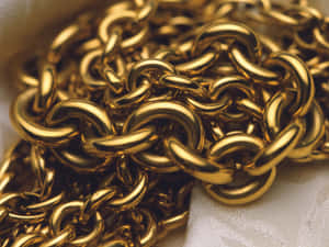 Delight In The Luxurious Shine Of A Gold Chain Wallpaper