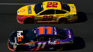 Denny Hamlin Against Race Car 22 Wallpaper