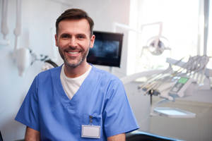 Dentist Smiling At The Camera Wallpaper